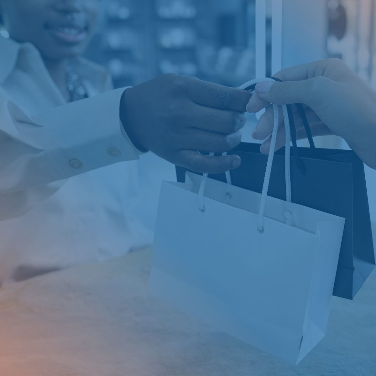 a women giving a man 2 small shopping bags