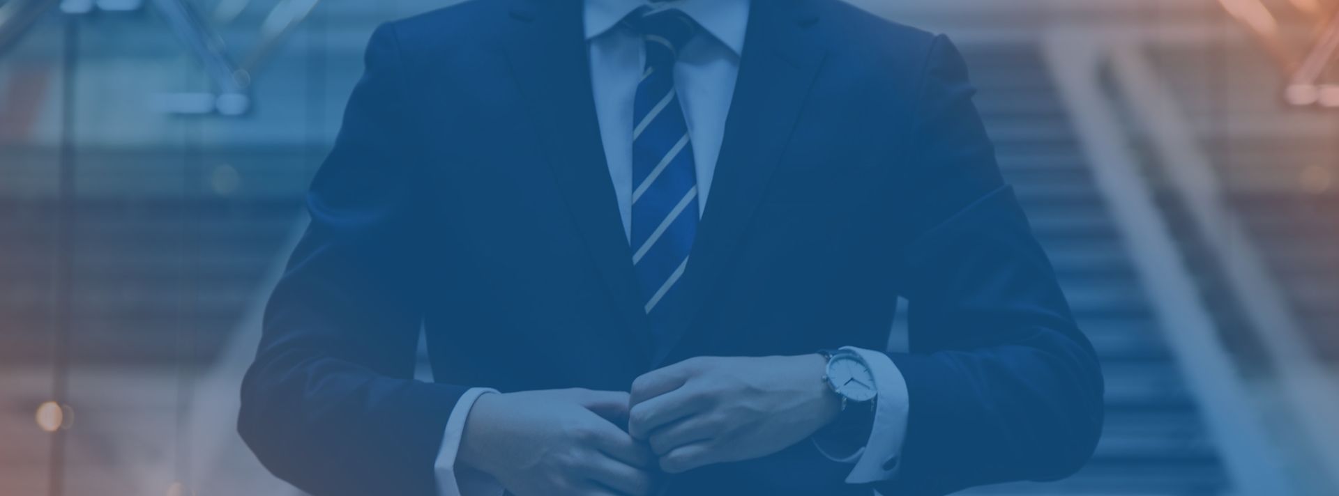 a man buttoning his formal suit