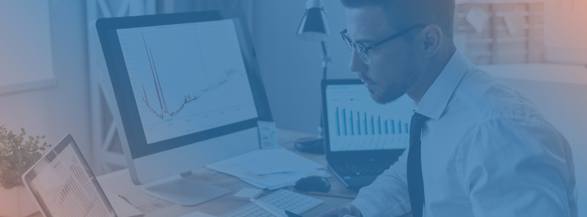 man evaluating different bar graphs for reporting