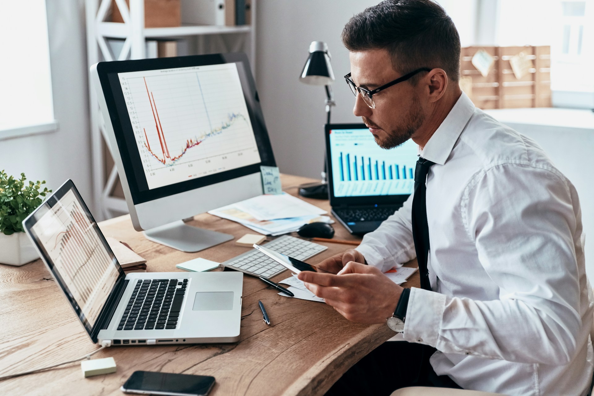 man evaluating different bar graphs for reporting